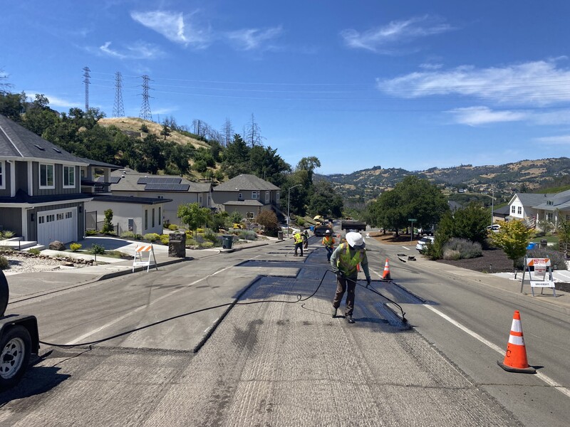 Applying tack oil so that the new asphalt will bond to the existing road