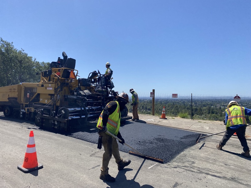Replacing a damaged section of the road surface with new asphalt