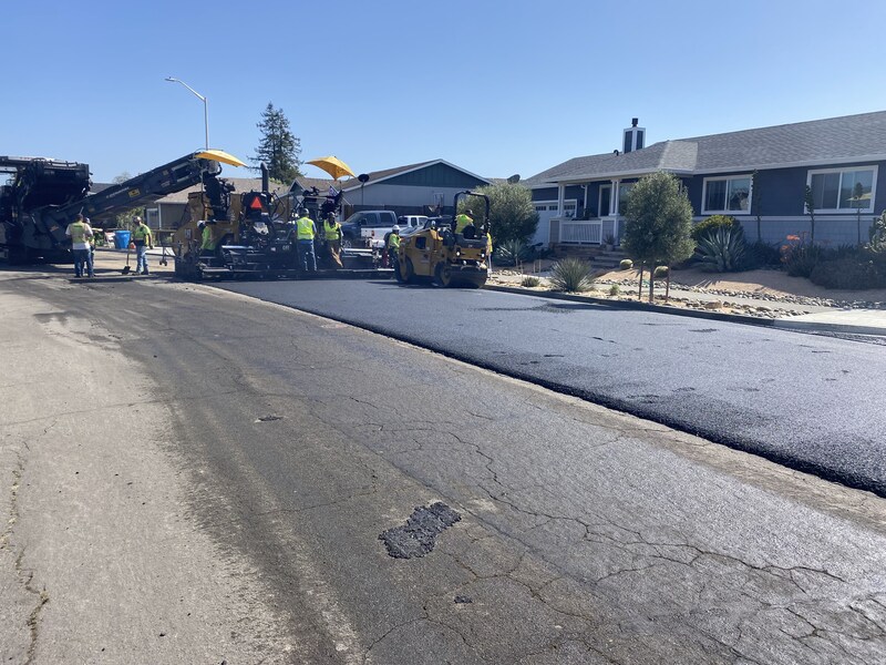 Pouring and smoothing out the hot asphalt